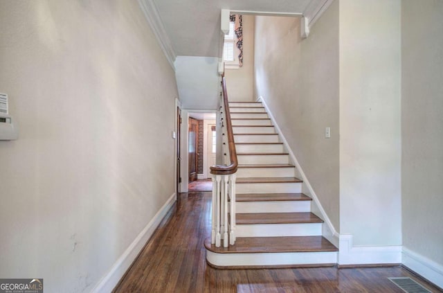 stairway with hardwood / wood-style floors and crown molding