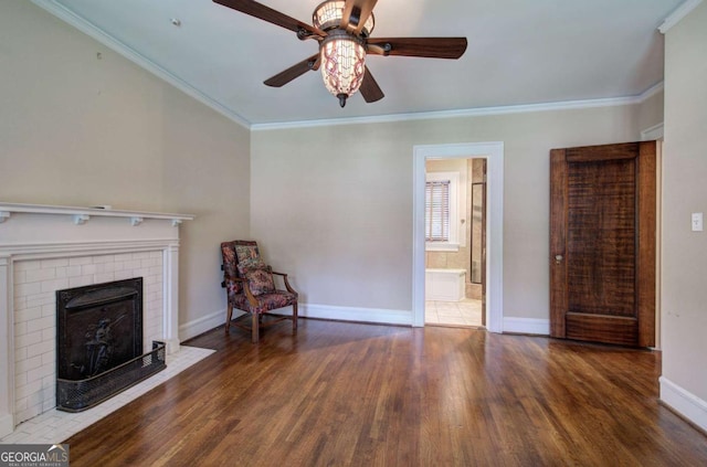 unfurnished living room with crown molding, ceiling fan, and dark hardwood / wood-style floors