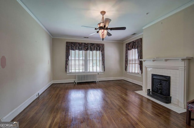 unfurnished living room with dark hardwood / wood-style floors, crown molding, radiator, and a fireplace