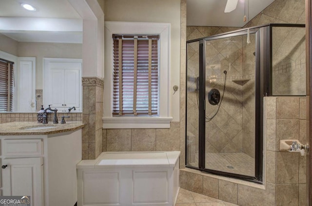 bathroom featuring tile walls, an enclosed shower, vanity, and ceiling fan