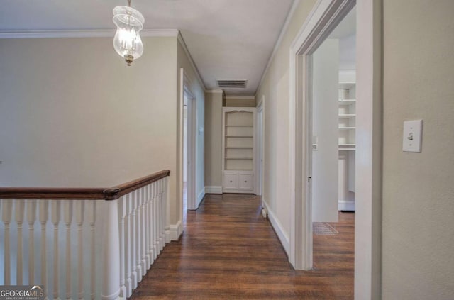 corridor featuring dark hardwood / wood-style flooring, crown molding, and built in features