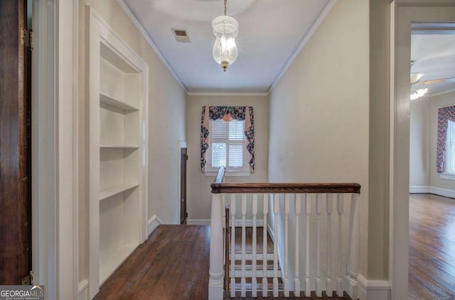 hallway featuring ornamental molding, dark wood-type flooring, and built in features