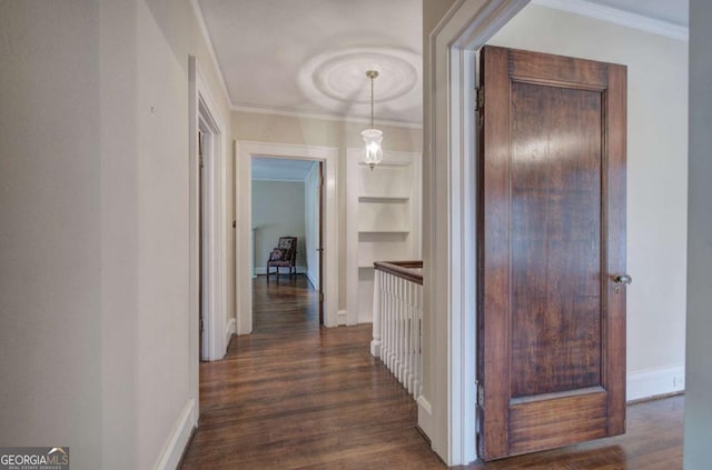 corridor with dark hardwood / wood-style flooring, ornamental molding, and built in features