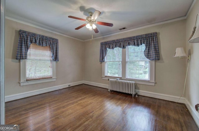 empty room with ornamental molding, radiator, dark wood-type flooring, and ceiling fan