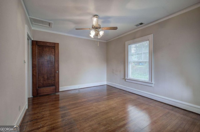 empty room featuring dark wood-type flooring, ceiling fan, and ornamental molding