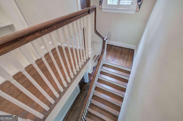 stairway with hardwood / wood-style floors