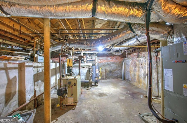 basement featuring heating unit and gas water heater