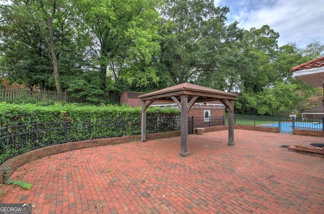 view of patio with a gazebo and a shed