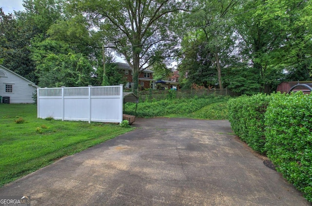 view of gate with a yard