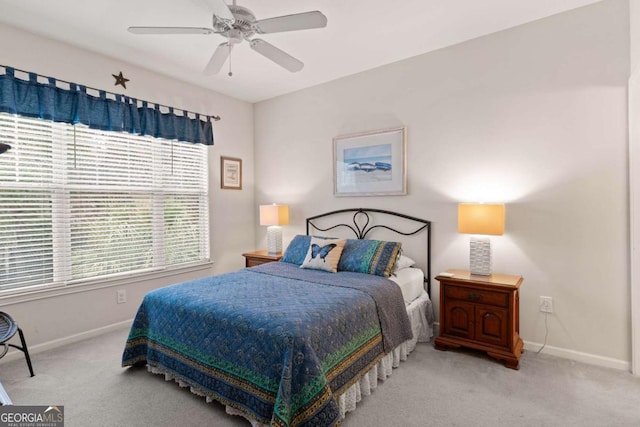 bedroom with ceiling fan and light carpet