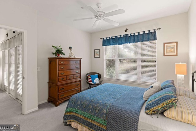 bedroom featuring access to outside, light carpet, and ceiling fan