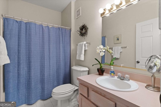 bathroom with vanity, tile patterned floors, and toilet