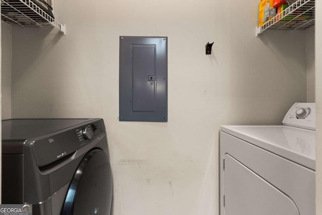 laundry room with washer and clothes dryer and electric panel