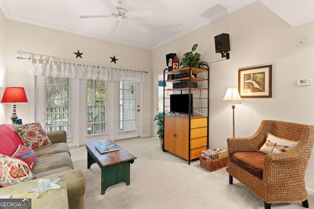 carpeted living room featuring crown molding and ceiling fan