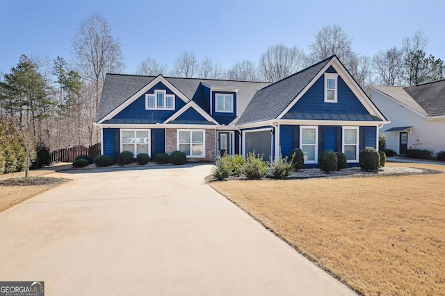 view of front of home with a garage, a front yard, and driveway