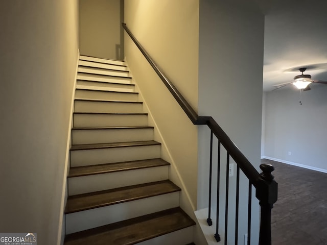 staircase featuring ceiling fan