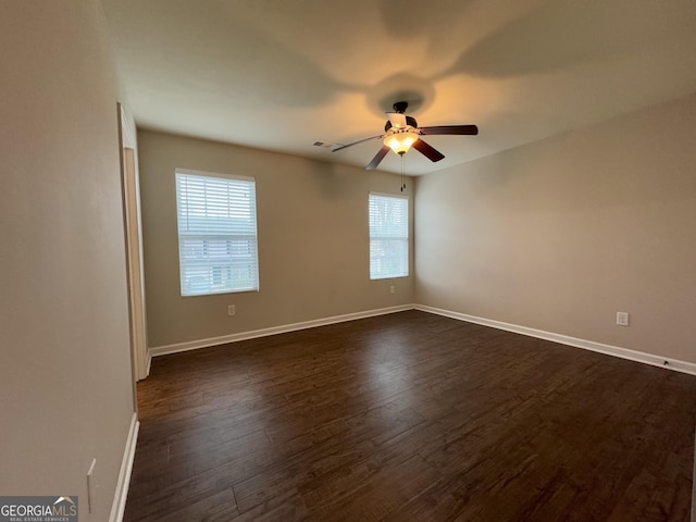 unfurnished room with dark wood-type flooring and ceiling fan