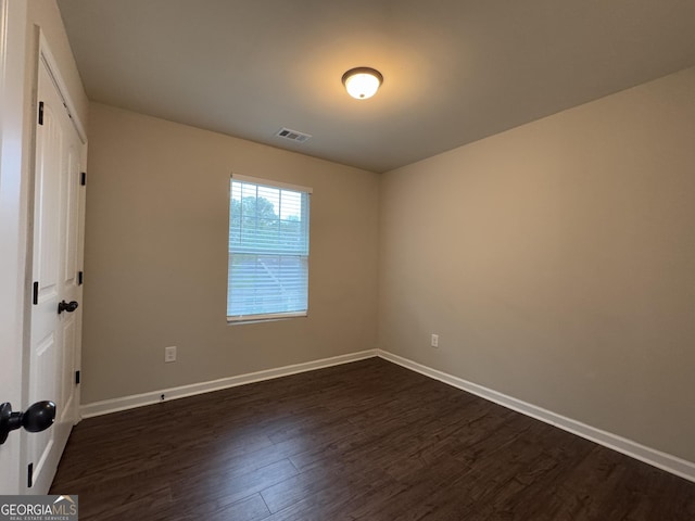 spare room featuring dark hardwood / wood-style floors