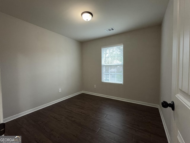 spare room featuring dark wood-type flooring