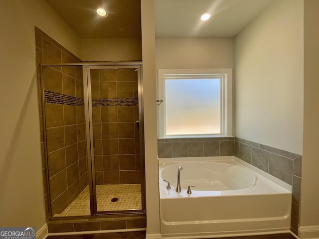 bathroom featuring recessed lighting, a shower stall, and a bath