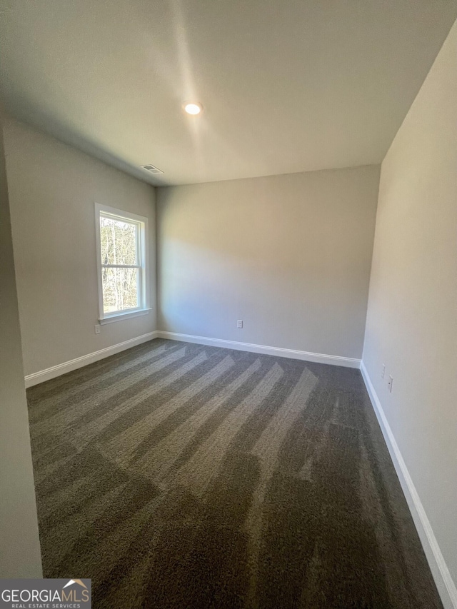 unfurnished room featuring recessed lighting, visible vents, dark carpet, and baseboards