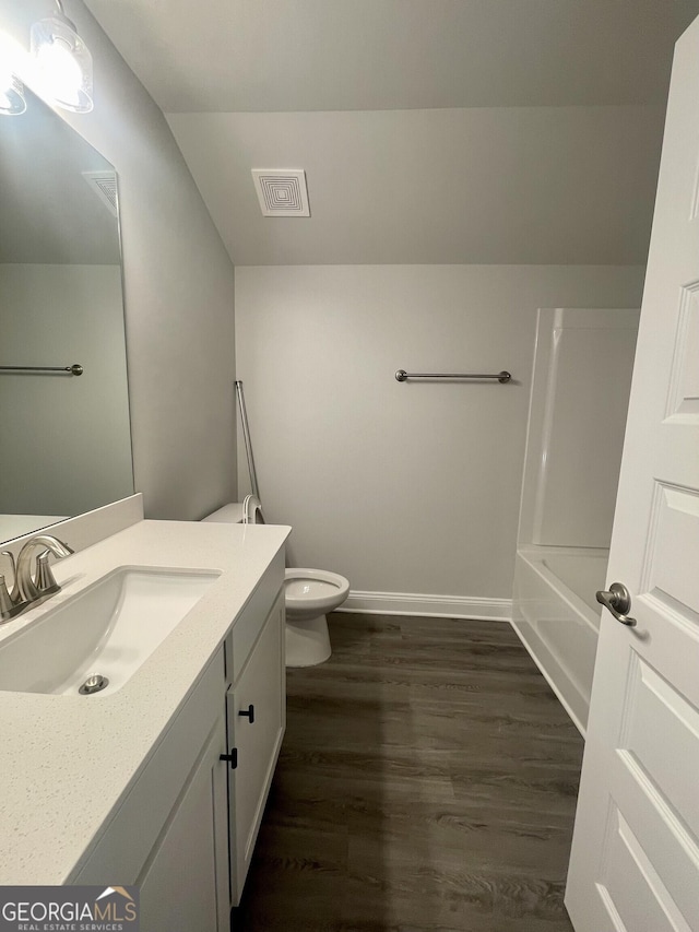 full bath with toilet, wood finished floors, vanity, visible vents, and baseboards