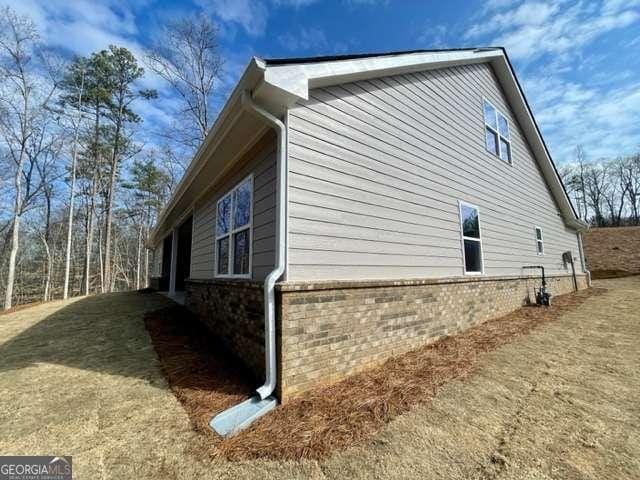 view of side of home featuring brick siding