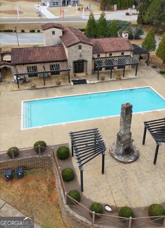 outdoor pool with a patio area