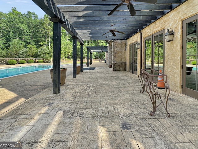 view of patio / terrace with an outdoor pool, a ceiling fan, and a pergola