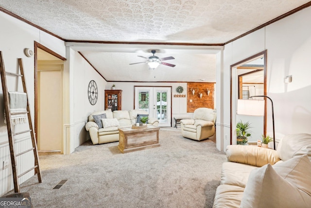 carpeted living room with crown molding, ceiling fan, a textured ceiling, and french doors