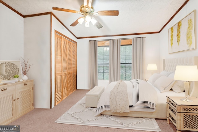 carpeted bedroom featuring crown molding, a closet, and a textured ceiling