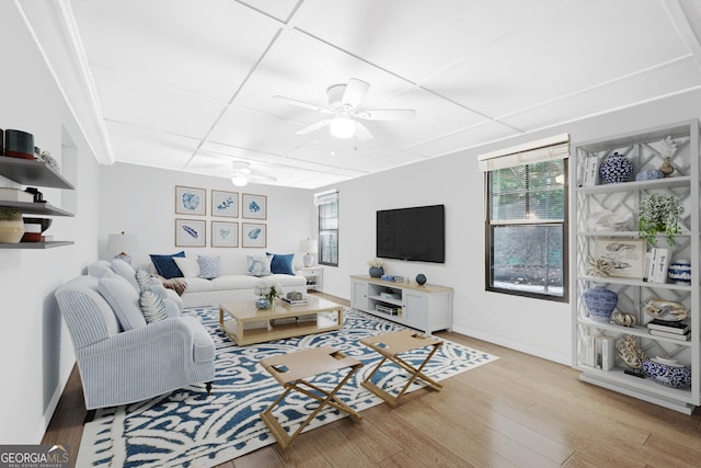 living room with ceiling fan, light hardwood / wood-style floors, and a drop ceiling