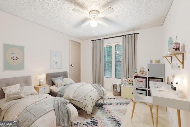 bedroom with ceiling fan, light colored carpet, and a textured ceiling