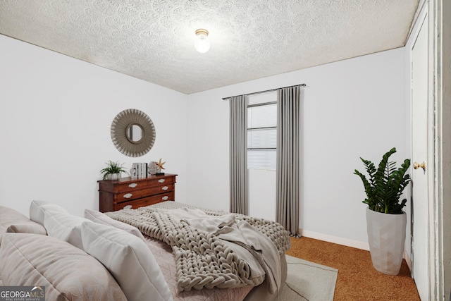 carpeted bedroom with a textured ceiling