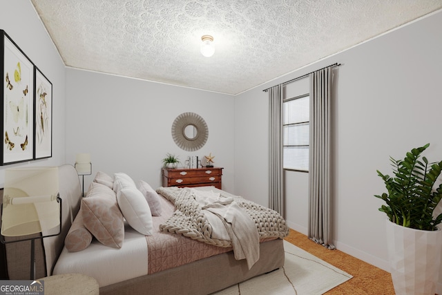 carpeted bedroom featuring a textured ceiling