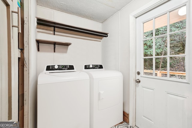 laundry room featuring independent washer and dryer, a textured ceiling, and a wealth of natural light