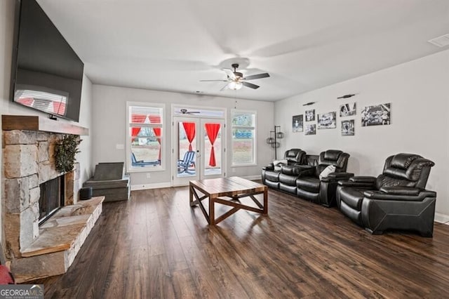 living room featuring a fireplace, dark wood-type flooring, french doors, and ceiling fan