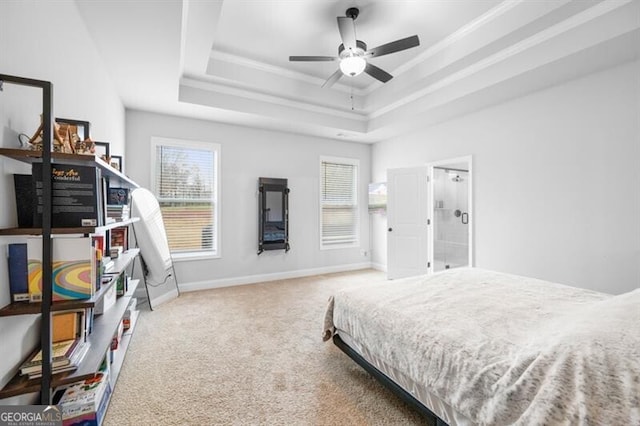 bedroom featuring ornamental molding, carpet, ceiling fan, and a tray ceiling