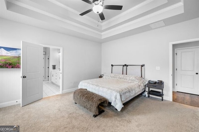 bedroom featuring light carpet, ornamental molding, and a raised ceiling