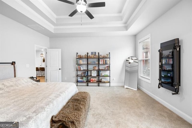 carpeted bedroom featuring crown molding, ceiling fan, and a tray ceiling