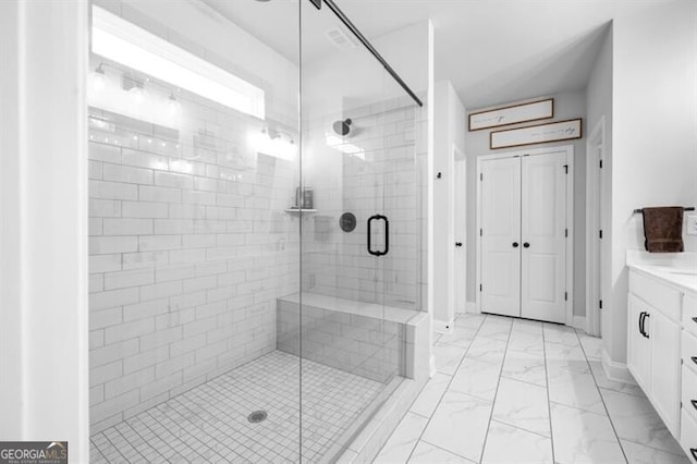 bathroom with vanity and a shower with shower door