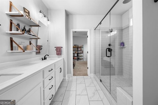 bathroom featuring a shower with door and vanity