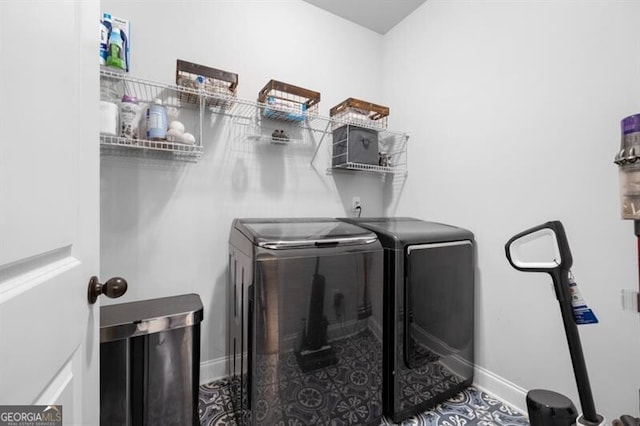 clothes washing area featuring tile patterned flooring and washing machine and dryer