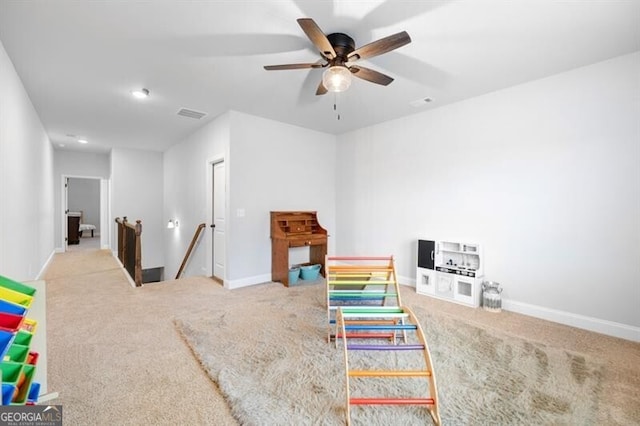 playroom with light colored carpet and ceiling fan