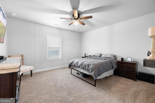 carpeted bedroom with multiple windows and ceiling fan