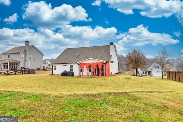 rear view of property featuring a yard