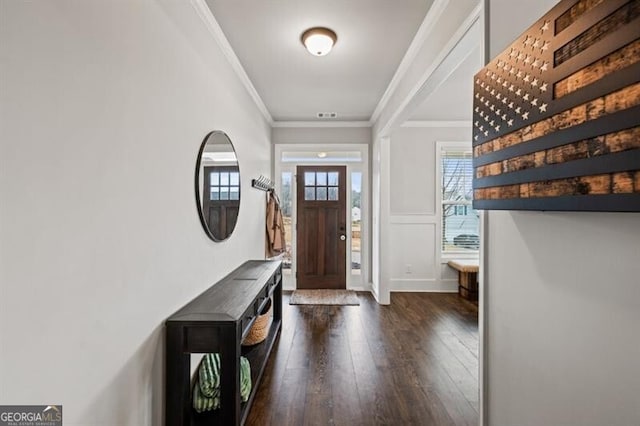 entryway with ornamental molding and dark wood-type flooring