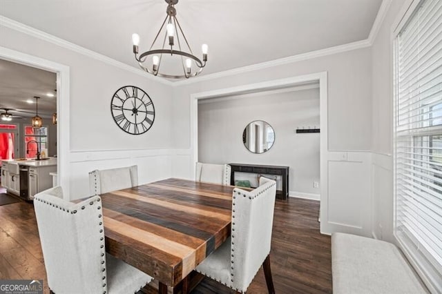 dining space featuring ornamental molding, dark hardwood / wood-style floors, and sink