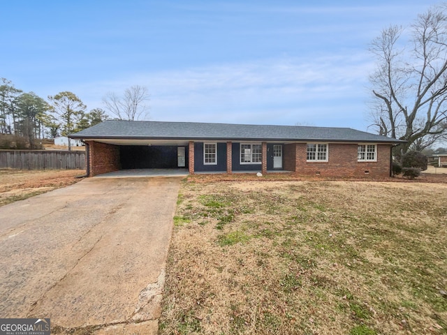 ranch-style home featuring a carport and a front lawn