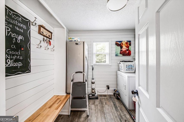 mudroom featuring wooden walls, a textured ceiling, and dark hardwood / wood-style flooring